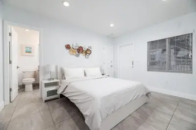 a white bedroom with a bed and a toilet at Bayshore Breeze 2 in Fort Lauderdale