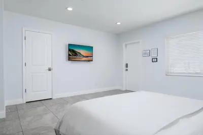a white bedroom with a bed and a window at Bayshore Breeze Free Parking 3 in Fort Lauderdale