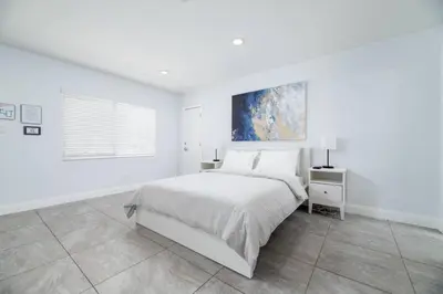 a white bedroom with a bed and a window at Bayshore Breeze Free Parking 3 in Fort Lauderdale