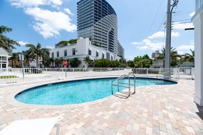 a swimming pool with a building in the background at Bayshore Breeze 6 in Fort Lauderdale