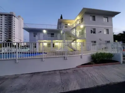 a white house with a white fence in front of it at Bayshore Breeze 8 in Fort Lauderdale