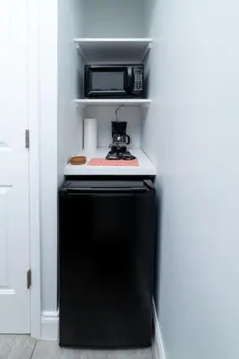 a black refrigerator with a microwave on top of it at Bayshore Breeze 8 in Fort Lauderdale