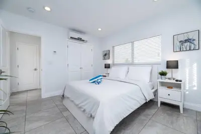 a white bedroom with a bed and a window at Bayshore Breeze Free Parking 9 in Fort Lauderdale