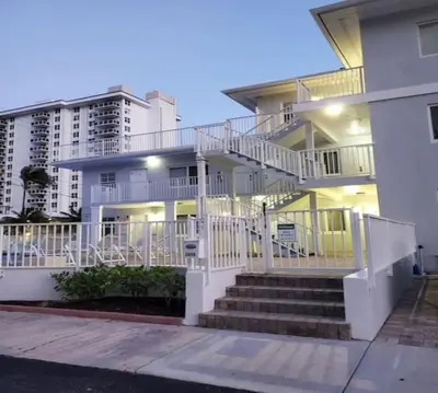 a white house with stairs in front of it at Bayshore Breeze Free Parking 9 in Fort Lauderdale