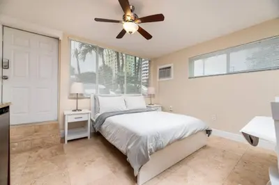 a bedroom with a bed and a ceiling fan at Ocean Breeze Free Parking Apt 1 in Fort Lauderdale