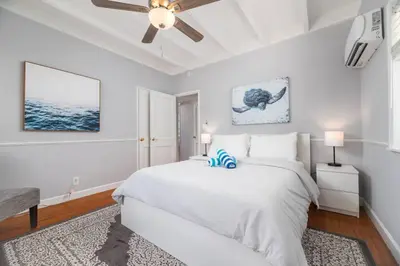 a white bedroom with a bed and a ceiling fan at Ocean Breeze Free Parking Apt 3 in Fort Lauderdale