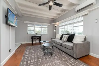 a living room with a couch and a tv at Ocean Breeze Free Parking Apt 3 in Fort Lauderdale