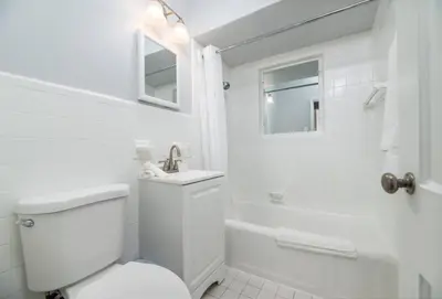 a white bathroom with a toilet and a shower at Ocean Breeze Free Parking Apt 5 in Fort Lauderdale