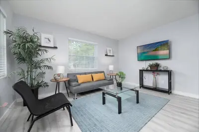 a living room with a couch and a table at Short Walk to Wilton Drive Apt1 in Fort Lauderdale