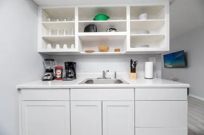 a kitchen with white cabinets and a sink at Short Walk to Wilton Drive Apt2 in Fort Lauderdale