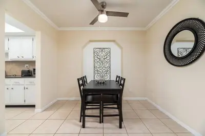 a dining room with a table and chairs and a mirror at Short Walk to Wilton Drive Apt3 in Fort Lauderdale