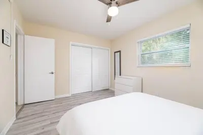 a white bedroom with a bed and a window at Short Walk to Wilton Drive Apt3 in Fort Lauderdale