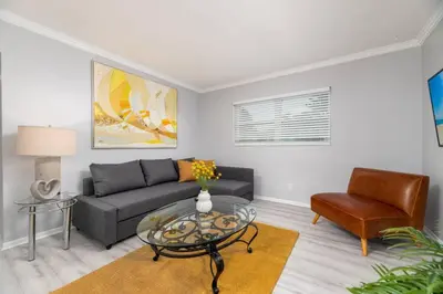 a living room with a couch and a table and a chair at Short Walk to Wilton Drive Apt4 in Fort Lauderdale