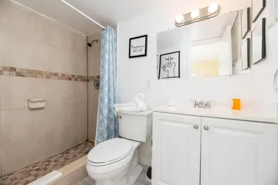 a bathroom with a toilet and a sink and a shower at Short Walk to Wilton Drive Apt6 in Fort Lauderdale