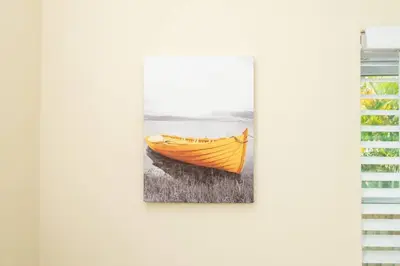 a painting of a yellow boat hanging on a wall at Short Walk to Wilton Drive Apt6 in Fort Lauderdale