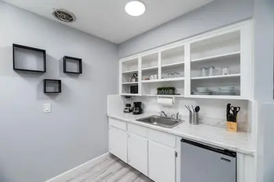 a kitchen with white cabinets and a sink at Just Off Wilton Drive Apt 2 in Fort Lauderdale