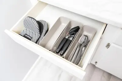a drawer filled with utensils in a white cabinet at Just Off Wilton Drive Apt 2 in Fort Lauderdale