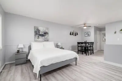 a white bedroom with a bed and a dining room at Just Off Wilton Drive Apt 4 in Fort Lauderdale