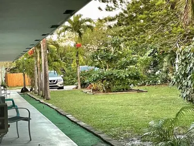 a view of a yard with a car parked in a park at Just Off Wilton Drive Apt 4 in Fort Lauderdale