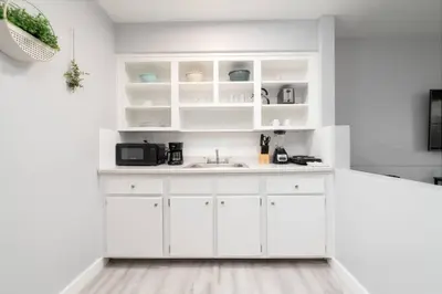a kitchen with white cabinets and a sink at Just Off Wilton Drive Apt 4 in Fort Lauderdale