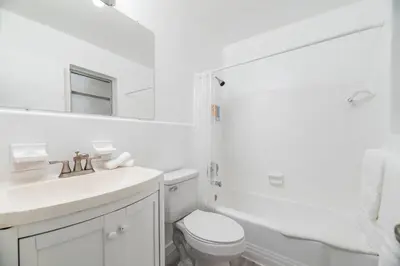 a white bathroom with a sink and a toilet at Just Off Wilton Drive Apt 5 in Fort Lauderdale