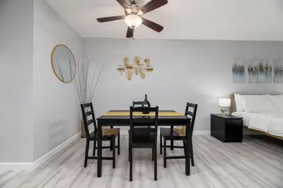 a dining room with a table and chairs and a bed at Just Off Wilton Drive Apt 5 in Fort Lauderdale