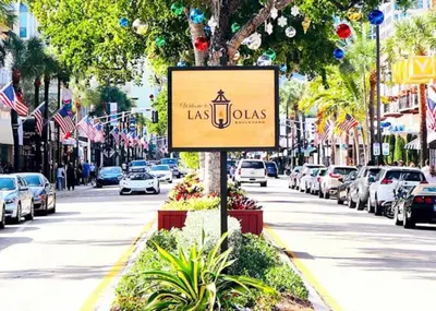 a sign on a city street with cars parked at Comfy Condos at Middle River Apt 1 in Fort Lauderdale
