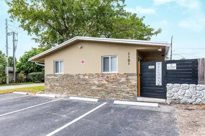 a house with a garage door and a driveway at Comfy Condos at Middle River Apt 1 in Fort Lauderdale