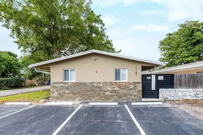a house with a parking lot in front of it at Comfy Condos at Middle River Apt 1 in Fort Lauderdale