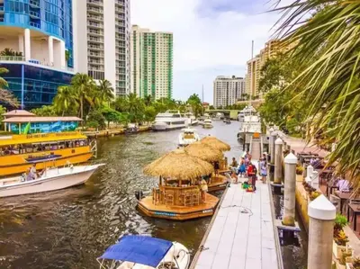 a group of boats in a river with buildings at Comfy Condos at Middle River Apt 1 in Fort Lauderdale