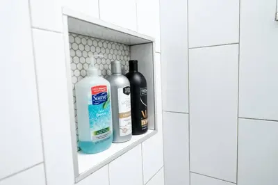 a shelf in a bathroom with three bottles of cleaner at Comfy Condos at Middle River Apt 2 in Fort Lauderdale