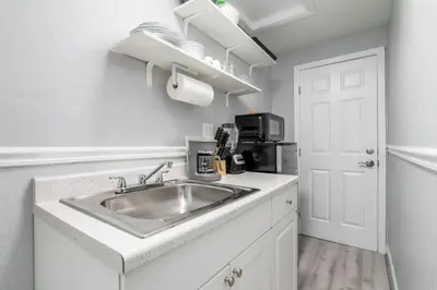 a kitchen with a sink and a microwave at The Dolphin Studio at Lake Ridge in Fort Lauderdale