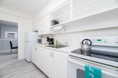 a white kitchen with a sink and a refrigerator at The Residences at Lake Ridge Apt 3 in Fort Lauderdale