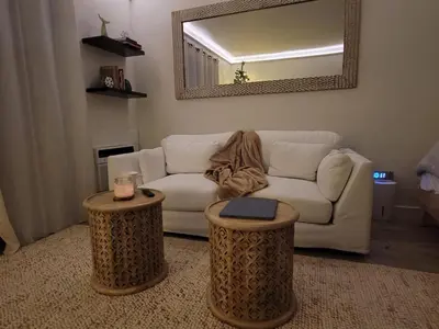 a living room with a white couch and two tables at Tropical Oasis Getaway in Miami Beach