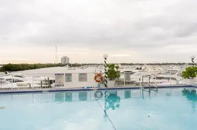 a large swimming pool with a view of a marina at Tropical Oasis Getaway in Miami Beach