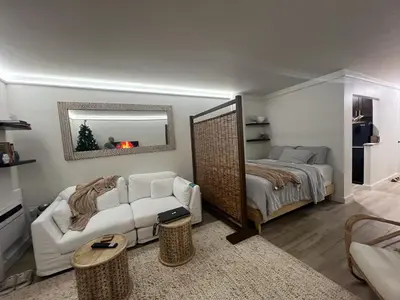 a living room with a bed and a mirror at Tropical Oasis Getaway in Miami Beach