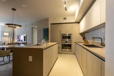 a large kitchen with a counter and a dining room at LYFE on the Beach 25th floor 1 bed unit with Oceanview in Hollywood