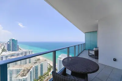 a balcony with a table and a view of the ocean at LYFE on the Beach 25th floor 1 bed unit with Oceanview in Hollywood