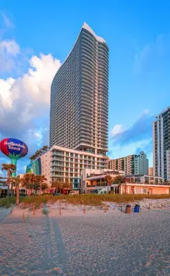 a beach with a large building in the background at LYFE on the Beach 25th floor 1 bed unit with Oceanview in Hollywood