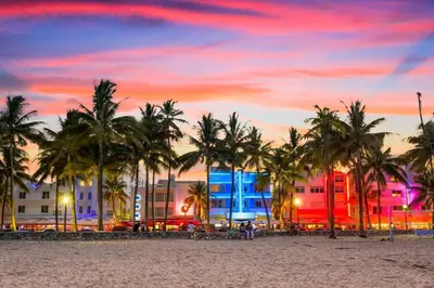 a beach with palm trees and buildings at sunset at Designer Home w Pool & Firepit - 7 min to Brickell in Miami