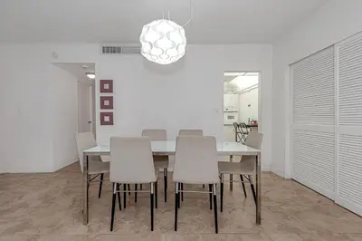 a dining room with a table and chairs at Hollywood on The Beach in Hollywood