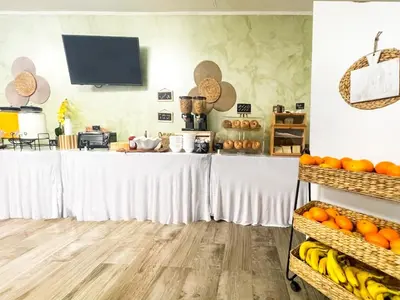 a table with bananas and oranges in a room at Coastal Sunset in Hollywood
