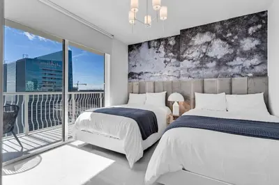 a bedroom with two beds and a balcony at Luxe Brickell Gem with Huge Balcony n Ocean Views in Miami