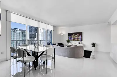a living room with a table and a couch at Luxe Brickell Gem with Huge Balcony n Ocean Views in Miami