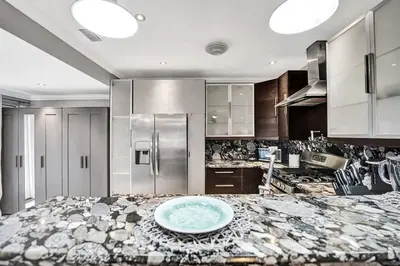 a kitchen with a blue bowl on top of a counter at Beach Isles Modern 1BR Waterfront Apartment with Patio in Fort Lauderdale