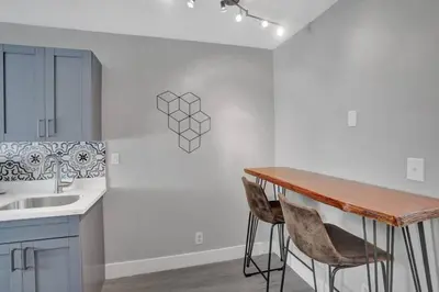 a kitchen with a table and two chairs next to a sink at Rustic Retreats Beachy 1BR for 4 guests in the heart of Fort Lauderdale in Fort Lauderdale