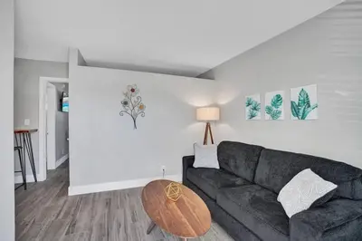 a living room with a couch and a table at Rustic Retreats Beachy 1BR for 4 guests in the heart of Fort Lauderdale in Fort Lauderdale