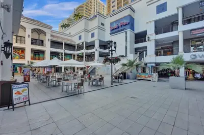 an empty shopping mall with tables and chairs and buildings at Rustic Retreats Beachy 1BR for 4 guests in the heart of Fort Lauderdale in Fort Lauderdale
