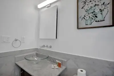 a bathroom with a sink and a mirror at Beach Isles Modern 1BR Apartment in Fort Lauderdale in Fort Lauderdale