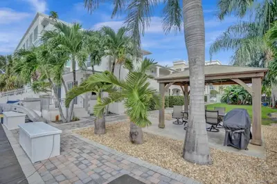 a patio with palm trees and a gazebo at Beach Isles Modern Studio Apartment in Fort Lauderdale in Fort Lauderdale